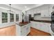 Charming kitchen features an island, stainless steel appliances, and a sunlit breakfast nook at 11660 Windbrooke Way, Johns Creek, GA 30005