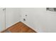 A clean laundry room features a door, flooring and visible hookups for a washer and dryer at 11660 Windbrooke Way, Johns Creek, GA 30005