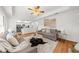 Bright living room connected to the kitchen featuring modern decor and comfortable seating at 11660 Windbrooke Way, Johns Creek, GA 30005