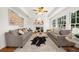 Bright living room features a fireplace and tray ceiling at 11660 Windbrooke Way, Johns Creek, GA 30005