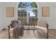 The living room has a large window, 2 chairs, and minimalistic decorations at 11660 Windbrooke Way, Johns Creek, GA 30005
