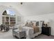 A view of the main bedroom, which features a seating area and large window at 11660 Windbrooke Way, Johns Creek, GA 30005