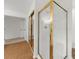 Glass shower with gold trim adjacent to closet with mirrored doors at 11660 Windbrooke Way, Johns Creek, GA 30005