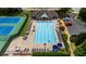 Aerial shot of the community pool area, featuring a large pool, lounge chairs, tables, and umbrellas at 11660 Windbrooke Way, Johns Creek, GA 30005