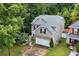 Aerial view of gray home showing landscaping and driveway at 2468 Whistle Stop Dr, Norcross, GA 30071