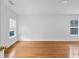 Empty bedroom showcasing hardwood floors, white walls, and natural light streaming through two windows at 2468 Whistle Stop Dr, Norcross, GA 30071