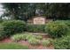 Stone entryway sign for Old Norcross Station nestled among lush greenery creates a welcoming community entrance at 2468 Whistle Stop Dr, Norcross, GA 30071