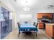Dining room adjacent to kitchen with hardwood floors and modern lighting at 2468 Whistle Stop Dr, Norcross, GA 30071
