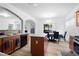 Bright kitchen features an island, black appliances, and a view of an adjacent dining area and living room at 2468 Whistle Stop Dr, Norcross, GA 30071