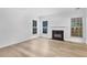 Bright, open living room featuring a fireplace, hardwood floors, and lots of natural light at 2468 Whistle Stop Dr, Norcross, GA 30071