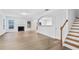 Bright living room featuring hardwood floors, a fireplace, and open access to other rooms at 2468 Whistle Stop Dr, Norcross, GA 30071