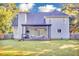 Expansive backyard with a lush green lawn and a charming covered patio perfect for relaxing and entertaining at 3568 Foxworth Ct, Buford, GA 30519
