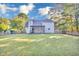 Large backyard featuring a well-maintained lawn and a covered patio, offering an ideal space for outdoor activities at 3568 Foxworth Ct, Buford, GA 30519