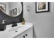 Elegant half bath featuring modern sink and decorative mirror with updated fixtures at 3568 Foxworth Ct, Buford, GA 30519