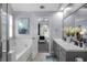 View from a bright bathroom showcasing double sinks, bathtub/shower and view into main bedroom at 3568 Foxworth Ct, Buford, GA 30519