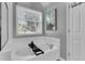 Bright bathroom with a soaking tub under a window, white subway tile, and neutral wall color at 3568 Foxworth Ct, Buford, GA 30519
