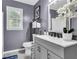 Charming bathroom with updated vanity, sink, and decorative mirror and storage at 3568 Foxworth Ct, Buford, GA 30519