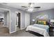 Neutral bedroom featuring gray walls, carpet, a ceiling fan, and contemporary furniture with colorful pillows and accent art at 3568 Foxworth Ct, Buford, GA 30519