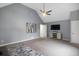 Spacious bonus room with gray walls, carpet, a vaulted ceiling, and contemporary furniture and decor at 3568 Foxworth Ct, Buford, GA 30519