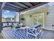 Relaxing covered patio featuring stylish furniture, a patterned rug, and access to the home's interior at 3568 Foxworth Ct, Buford, GA 30519