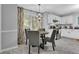 Cozy dining area with modern light fixture and view of bright window with patterned curtains at 3568 Foxworth Ct, Buford, GA 30519
