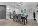 Dining area with gray wooden floors, a dark wood table, and a modern light fixture at 3568 Foxworth Ct, Buford, GA 30519