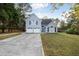 Charming two-story home boasts a well-manicured lawn, attached two car garage, and a long concrete driveway at 3568 Foxworth Ct, Buford, GA 30519