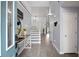 Bright and airy foyer with staircase, wood floors and a pop of color in the custom blue front door at 3568 Foxworth Ct, Buford, GA 30519
