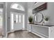 Inviting foyer features wood flooring, a stylish console table, and a striking arched window above the entrance at 3568 Foxworth Ct, Buford, GA 30519