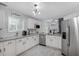 Bright kitchen with stainless steel appliances, granite countertops, and ample white cabinetry at 3568 Foxworth Ct, Buford, GA 30519