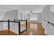 Inviting bonus room features hardwood floors, ceiling fan, and custom built-in shelving at 5696 Kilrush Se Ct, Mableton, GA 30126