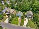 An aerial view of three homes showcasing their well-manicured lawns and neighborhood at 2355 Ewing Ne Dr, Brookhaven, GA 30319