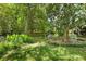 Landscaped backyard with grass and trees with garden decor and furniture at 2355 Ewing Ne Dr, Brookhaven, GA 30319