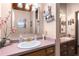 Bathroom with double sinks, wood cabinets, and a unique red countertop at 2355 Ewing Ne Dr, Brookhaven, GA 30319