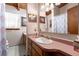 Classic bathroom featuring a wood vanity, red countertop, and framed mirrors at 2355 Ewing Ne Dr, Brookhaven, GA 30319