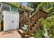 Wooden deck stairs with lattice and white storage building at 2355 Ewing Ne Dr, Brookhaven, GA 30319