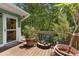 View of wooden deck with flower pots and decorative heron, outside green house with glass door at 2355 Ewing Ne Dr, Brookhaven, GA 30319