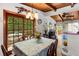 Inviting dining area with wood-beamed ceilings and sliding glass doors leading to an outdoor deck at 2355 Ewing Ne Dr, Brookhaven, GA 30319