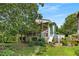 Home exterior with patio, backyard, stairs to upper deck, storage shed, and greenery at 2355 Ewing Ne Dr, Brookhaven, GA 30319