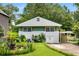 Charming cottage-style home with a well-manicured front yard, plants, and a carport at 2355 Ewing Ne Dr, Brookhaven, GA 30319