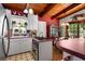 Well-lit kitchen and dining room featuring wood beamed ceilings, adjacent to the dining area at 2355 Ewing Ne Dr, Brookhaven, GA 30319