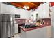 Cozy kitchen featuring white cabinets, stainless steel appliances, and a unique red countertop at 2355 Ewing Ne Dr, Brookhaven, GA 30319