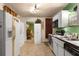 Kitchen with white appliances, tiled flooring, and modern lighting at 2355 Ewing Ne Dr, Brookhaven, GA 30319