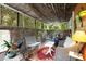 Covered outdoor patio with a variety of seating options and garden decor at 2355 Ewing Ne Dr, Brookhaven, GA 30319