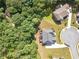Aerial view of a home with a large backyard and patio in a densely wooded area at 3202 Lucky Pl, Conyers, GA 30013