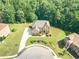Aerial view of a beautiful home with a long driveway and lush landscaping in a wooded setting at 3202 Lucky Pl, Conyers, GA 30013