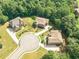 Aerial view of three homes in a cul-de-sac with large lots and well-manicured lawns at 3202 Lucky Pl, Conyers, GA 30013