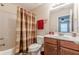 This is a bathroom with a shower and tub combo and brown-toned accents at 3202 Lucky Pl, Conyers, GA 30013