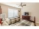 Bright bedroom features two beds with plaid bedding, ceiling fan and neutral wall color at 3202 Lucky Pl, Conyers, GA 30013