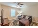 Cozy bedroom features a loveseat, ceiling fan and neutral wall color and a decorative rug at 3202 Lucky Pl, Conyers, GA 30013